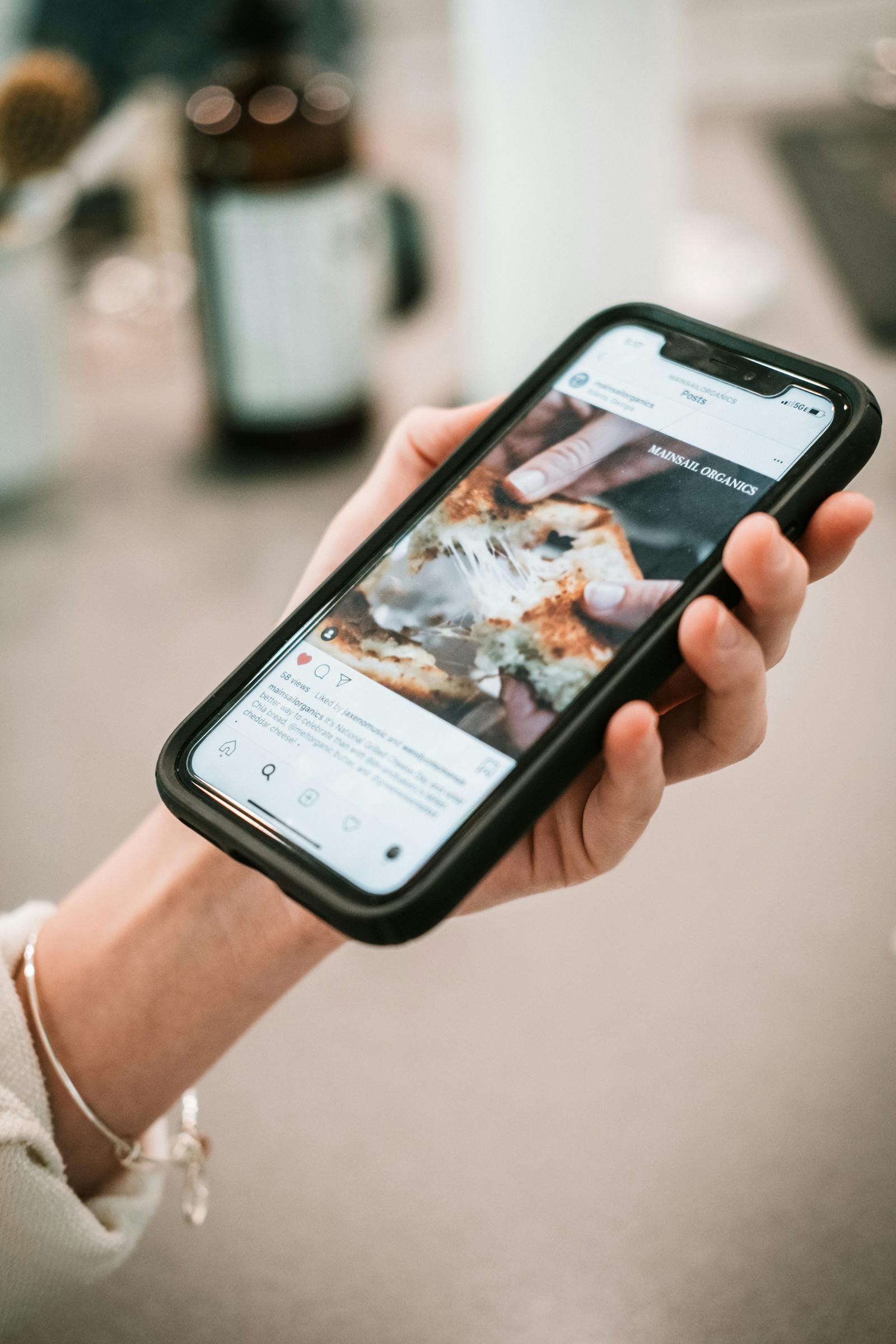 Hand holding smartphone with an app UI